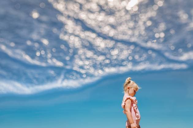 Creative Highlights Symbolbilder Young girl standing against blue sky with double exposure of water Beverly Shores, Indiana, United States R_WEKW230425-1176438-01 ,model released, Symbolfoto