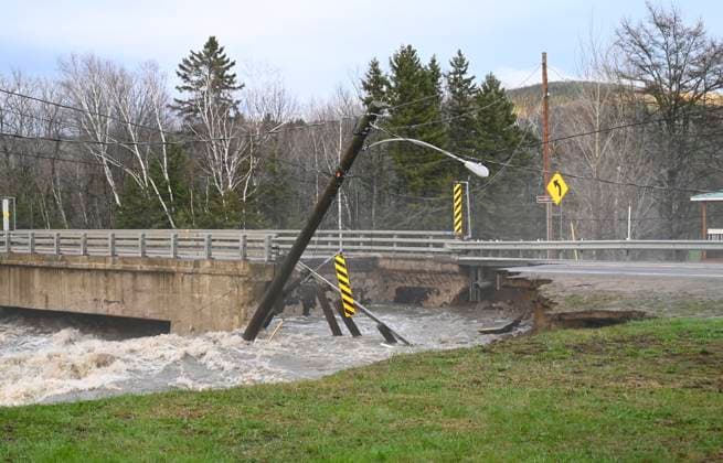 May 1, 2023, BAIE SAINT-PAUL, PQ, CANADA: A lamp power post dangles over the river as the bridge crossing in heavily damaged from flood waters in Baie-Saint-Paul, Quebec. In Baie-St-Paul, Que., around 90 kilometres northeast of the provincial capital, the mayor declared a state of emergency due to heavy rains that washed away roads and isolated homes. BAIE SAINT-PAUL CANADA  - ZUMAc35_ 20230501_zaf_c35_089 Copyright: xJacquesxBoissinotx