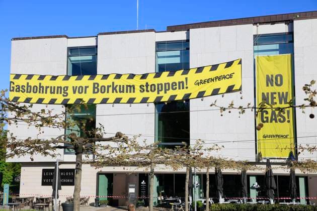 Protestaktion von Greenpeace vor dem Niedersächsischer Landtag gegen Gasbohrungen in der Nordsee vor Borkum, gelb-schwarze Banner an der Fassade des Landtag, Niedersachsen, Deutschland *** Protest action of Greenpeace in front of the parliament of Lower Saxony against gas drilling in the North Sea off Borkum, yellow black banners on the facade of the parliament, Lower Saxony, Germany