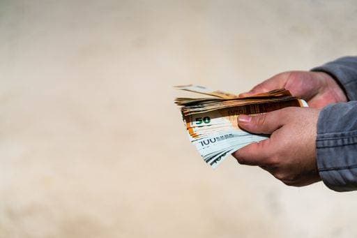 A man hand holding EURO banknotes on blurred background *** einer Mann handgeschnitzten haltend Euro¡± Geldscheine am unscharf Hintergrund 3776505