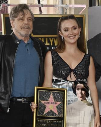 Billie Lourd, the daughter of actress Carrie Fisher is joined by actor Mark Hamill during a posthumous unveiling ceremony honoring Fisher with the 2,754th star on the Hollywood Walk of Fame in Los Angeles on Thursday, May 4, 2023. Coinciding with the unofficial Star Wars holiday May the 4th, but was overshadowed by a dispute among her daughter, who accepted the star on her mother s behalf, and Fisher s siblings, who weren t invited to the event.  LAP2023050416 JIMxRUYMEN