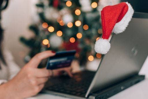 RECORD DATE NOT STATED Hand holding credit card, paying online on laptop, buying christmas presents. *** handgeschnitzten haltend Kredit card, bezahlend Onlinerechnung am laptop, kaufend Weihnachten präsentiert 3957932 ,model released, Symbolfoto
