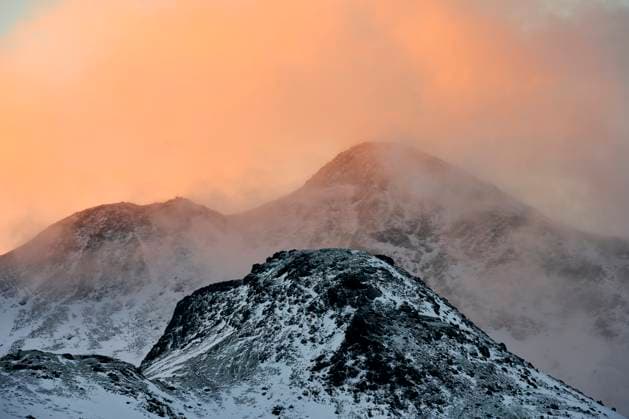 Creative Highlights World Snowy mountain ridge and clouds during sunset Reykjavík, Reykjavíkurborg, Iceland CR_OSBJ230503-1179487-01