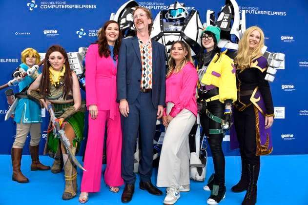 Katrin Bauerfeind, Uke Bosse und Olivia Osthushenrich aka Ollimeee mit Gamescom Bot und den Cosplayern Princess Link, Aloy, Killjoy und Zelda bei der Verleihung des Deutschen Computerspielpreises 2023 im Spindler & Klatt. Berlin, 11.05.2023