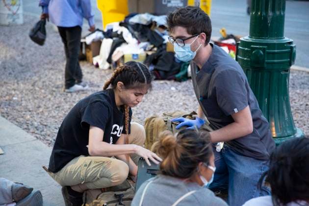 May 13, 2023, El Paso, Texas, USA: BRYCE KINNAIORD, a 24-year-old medical assistant and Army Veteran from Horizon City, Texas, treats minor injuries and illnesses of asylum-seekers from Venezuela, who crossed the border from Juarez, Mexico this week with the lifting of Title 42. Kinnaiord decided to come down to help out when he learned about the migrants living on the sidewalk outside the Sacred Heart Catholic Church. He pays for the bandages, ointments and over-the-counter medications himself. He said I believe people should come here the right way, but since they are here in our country, helping them is the right thing for us to do. The most common things he has been seeing, he said, are dehydration, covid, colds and headache. He e - ZUMAs li 20230513_new_s241_036 Copyright: xBelindaxSoncinix