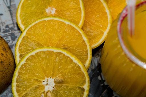 RECORD DATE NOT STATED A closeup of sliced lemons near a glass of juice *** einer closeupe des aufgeschnittenen Zitronen nahe einer Glas des Saft 6482386