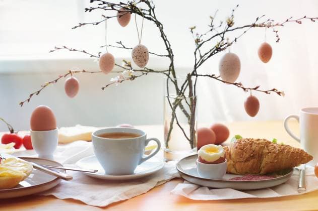 Easter breakfast in the morning sun with coffee and croissant on a table at the window, decoration from natural eggs hanging on spring branches, copy space, selected soft focus Easter breakfast in the morning sun with coffee and croissant on a table at the window, decoration from natural eggs hanging on spring branches, copy space, selected soft focus, narrow depth of field Copyright: xZoonar.com MarenxWinterx 19958141
