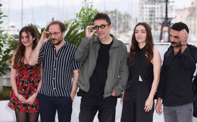 (230520) -- CANNES, May 20, 2023 -- Director Nuri Bilge Ceylan (C) poses with cast members during a photocall for the film Kuru Otlar Ustune (About Dry Grasses) at the 76th edition of the Cannes Film Festival in Cannes, southern France, May 20, 2023. The film Kuru Otlar Ustune (About Dry Grasses) will compete for the Palme d Or. ) FRANCE-CANNES-FILM FESTIVAL-KURU OTLAR USTUNE GaoxJing 