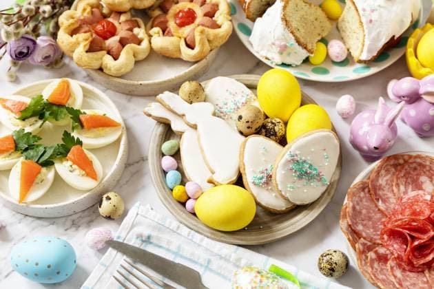 Festive dinner, Easter brunch. Easter table scene with an assortment of baking, desserts, stuffed eggs and dyed eggs on a marble background. Festive dinner, Easter brunch. Easter table scene with an assortment of baking, desserts, stuffed eggs and dyed eggs on a marble background. Copyright: xZoonar.com ELENAxHRAMOVAx 20013351
