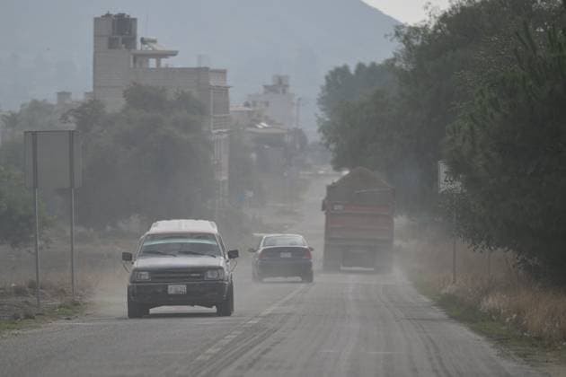 (230523) -- PUEBLA, May 23, 2023 -- This photo taken on May 22, 2023 shows vehicles passing through ash caused by the activity of the Popocatepetl volcano in the state of Puebla, Mexico. Mexican authorities on Sunday raised the alert level due to the recent increased activity of Popocatepetl volcano. The alert level was raised from yellow phase two to yellow phase three, one step below the red alert, said Laura Velazquez, head of the Mexican National Civil Protection Coordination Agency, at a press conference. ) MEXICO-PUEBLA-VOLCANO-POPOCATEPETL-ERUPTION XinxYuewei 