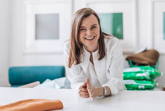 Happy fashion designer leaning on workbench model released, Symbolfoto property released, ADF00025