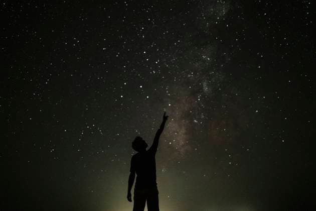 Silhouette of young man pointing towards stars model released, Symbolfoto, GMLF01456