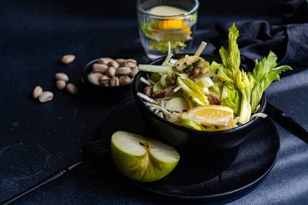 Healthy celery salad with apples and seeds served in the bowl in dark background AnnaBogush_ID13870_419030_005 Copyright: xAnnaxBogushx Model Released