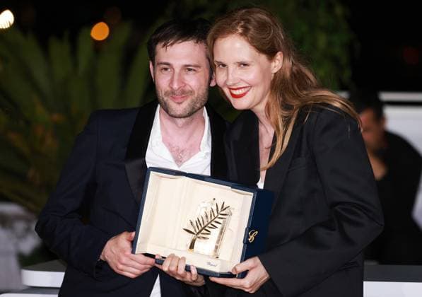 (230528) -- CANNES, May 28, 2023 -- French director Justine Triet (R) poses with the trophy during a photocall after she won the Palme d Or for the film Anatomie d une Chute (Anatomy of a Fall) during the closing ceremony of the 76th edition of the Cannes Film Festival in Cannes, southern France on May 27, 2023. French director Justine Triet was awarded with the Palme d Or at the 76th Cannes Film Festival for her Anatomy of a Fall on Saturday in Cannes, France, becoming the third female director winning this top prize. ) FRANCE-CANNES-FILM FESTIVAL-PALME D OR GaoxJing 