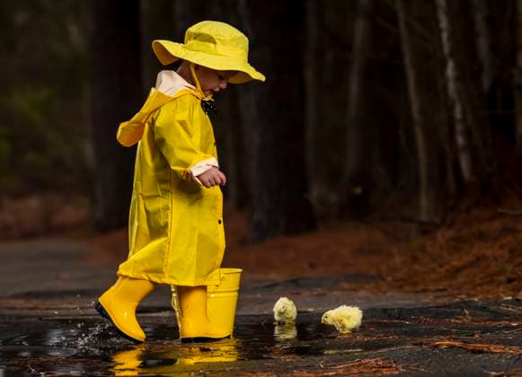 Child Enjoying The Rain In His Galoshes A small child plays in the rain while little chicks try to get a drink of water ,model released, Symbolfoto Copyright: xZoonar.com WalterxGxArcexSrxASPxIncx 13728445 ,model released, Symbolfoto ,property released