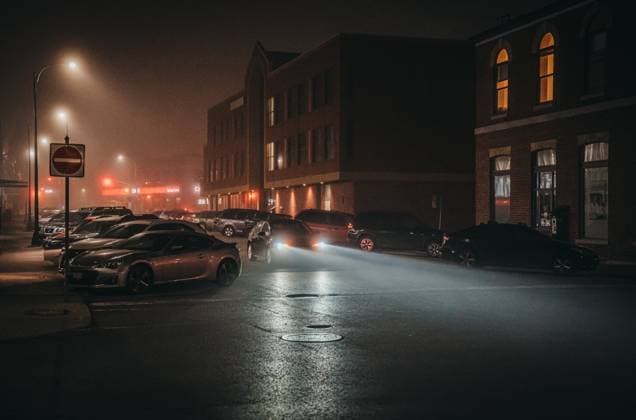 Car driving through a city street on a foggy autumn night. Kingston, Ontario, Canada R_DOHO221206C-1078719-01