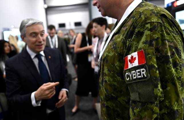 June 1, 2023, Ottawa, ON, CAN: Industry Minister Franvßois-Philippe Champagne speaks with a Canadian Forces member working in the Cyber Forces, at the CANSEC trade show, billed as North AmericaöÄÃ s largest multi-service defence event, in Ottawa, on Thursday, June 1, 2023. Ottawa CAN  - ZUMAc35_ 20230601_zaf_c35_030 Copyright: xJustinxTangx