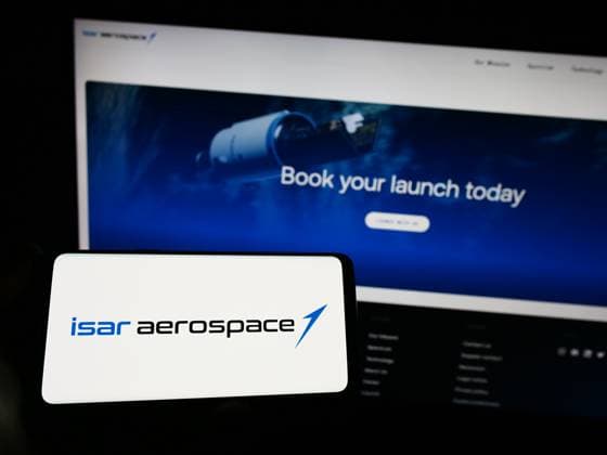 Person holding smartphone with logo of company Isar Aerospace Technologies GmbH on screen. Stuttgart, Germany - 04-02-2023: Person holding smartphone with logo of company Isar Aerospace Technologies GmbH on screen in front of website. Focus on phone display. Copyright: xZoonar.com TimonxSchneiderx 20149543