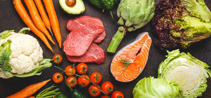 Assorted food raw products: vegetables, beef meat, fish salmon fillet on dark rustic brown stone table top view. Healthy food background, ingredients with vitamins concept, diet and nutrition Assorted food raw products: vegetables, beef meat steak, fish salmon fillet on dark rustic brown stone table top view. Healthy food background, ingredients with vitamins concept, diet and nutrition Copyright: xZoonar.com OlenaxYeromenkox 20190629