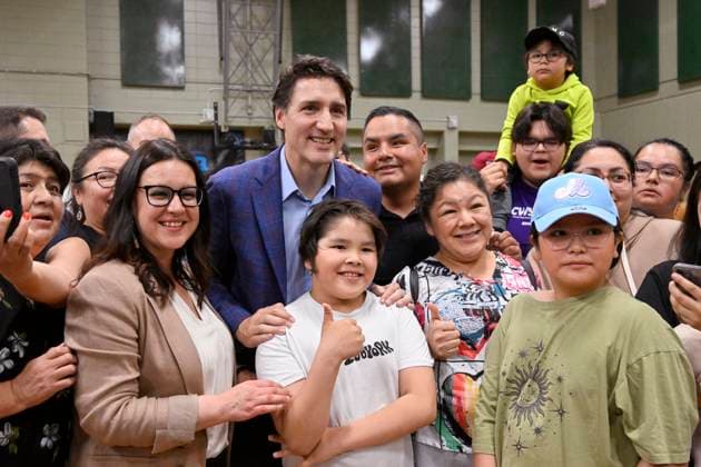 June 14, 2023, SAGUENAY, PQ, Canada: Prime Minister Justin Trudeau poses with Indigenous people of Ouje-Bougoumou who were evacuated because of wildfires, Wednesday, June 14, 2023 at Chicoutimi Cegep in Saguenay, Que. SAGUENAY Canada  - ZUMAc35_ 20230614_zaf_c35_026 Copyright: xJacquesxBoissinotx