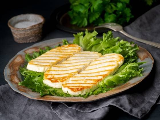 Grilled Halloumi, fried cheese with lettuce salad. Balanced diet on dark background, side view Grilled Halloumi, fried cheese with lettuce salad. Balanced diet on dark background, side view Copyright: xZoonar.com NataxBenex 17871883