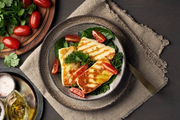 Cyprus fried halloumi cheese with healthy green salad. Lchf, pegan, fodmap, paleo, scd, keto diet. Cyprus fried halloumi cheese with healthy green salad. Lchf, pegan, fodmap, paleo, scd, keto, ketogenic diet. Balanced food, a greek clean eating recipe. Copyright: xZoonar.com NataliaxGdovskaiax 18249496