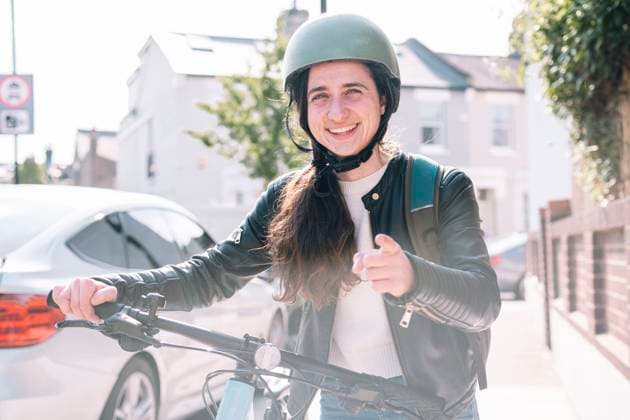 Happy delivery person gesturing with bicycle at footpath model released, Symbolfoto, AMWF01388