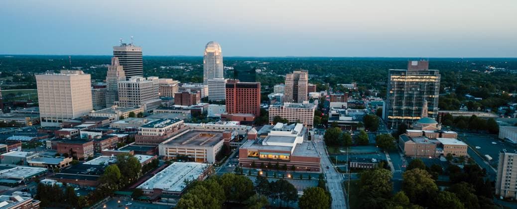 Aerial View as Night Falls on the Downtown City Skyline at Winston-Salem Winston-Salem North Carolina downtown city skyline illuminated at dusk Copyright: xZoonar.com ChristopherxBoswellx 12286485