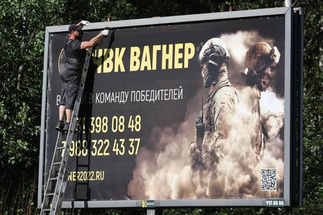 RUSSIA, ST PETERSBURG - JUNE 24, 2023: Removing a banner of PMC Wagner by Koltushskoye highway. Peter Kovalev TASS  60043363