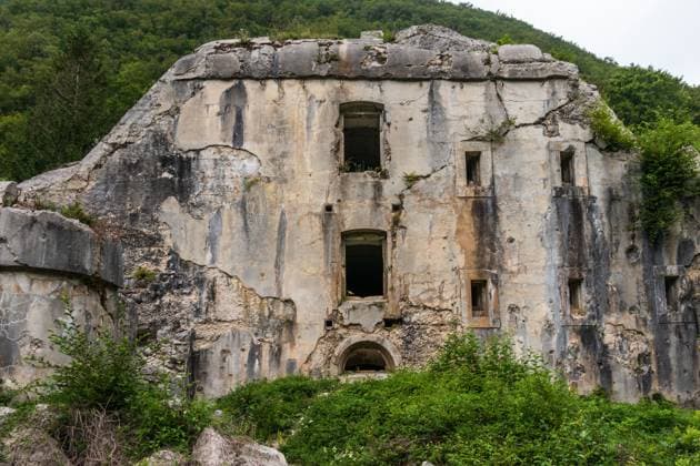 Detail view on Fort Hermann. Crumbling World War I Fortress near Mount Rombon. Bovec, Gorizia, Slovenia. The Koro?ka fort on the slope of Mt. Rombon was built as a support to the Klu?e Fort, between years 1897 and 1900, i.e. in Austria-Hungary. Med prvo svetovno vojno je bila zaradi silovitega italijanskega obstreljevanja mo?no po?kodovana. Today, informative signs have been placed next to the debris of the fort. Access to Fort Hermann: By foot, from the Klu?e Fort, on a wide marked route, which is carved into a rocky slope, through a 100 m long illuminated stone tunnel and then on the left path that climbs the Rombon. The walk to the fort takes a little less than half an hour. Copyright: xZoonar.com unununiusx 14323882