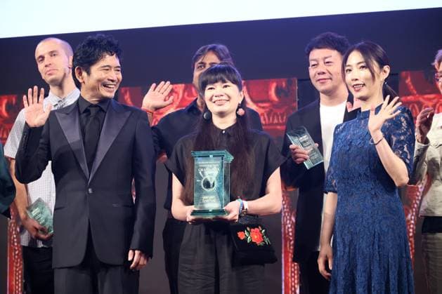June 26, 2023, Tokyo, Japan - Poland based Japanese animation artist Izumi Yoshida (C) holds the trophy of the George Lucas award at the awarding ceremony of the Short Shorts Film Festival & Asia 2023 in Tokyo on Monday, June 26, 2023, actor Masato Hagiwara (L) and actress Megumi (R) smile. Yoshida won the George Lucas award, grand prix of the film festival for her short animation movie The Bridge . (photo by Yoshio Tsunoda AFLO)  , aflo_222753582.jpg,
