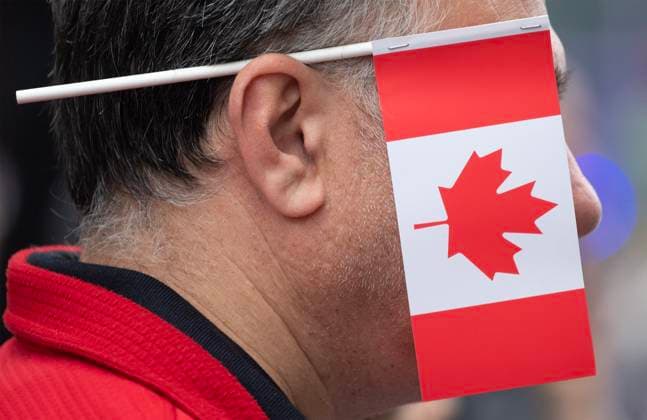 July 1, 2023, Montreal, PQ, Canada: A member of the crowd watches the Canada Day parade in Montreal, Saturday, July 1, 2023. Montreal Canada  - ZUMAc35_ 20230701_zaf_c35_002 Copyright: xGrahamxHughesx