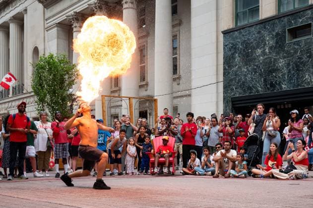 July 1, 2023, Ottawa, ON, Canada: A busker blows flames during a performance on Sparks St. as people take part in Canada Day celebrations in downtown Ottawa, on Saturday, July 1, 2023. Ottawa Canada  - ZUMAc35_ 20230701_zaf_c35_074 Copyright: xSpencerxColbyx