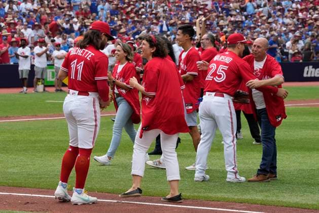 July 1, 2023, TORONTO, ON, Canada: People who took part in a Canada Day citizenship ceremony and the ceremonial first pitch greet the Blue Jays players before the start of MLB AL baseball action against the Boston Red Sox in Toronto on Saturday, July 1, 2023. TORONTO Canada  - ZUMAc35_ 20230701_zaf_c35_082 Copyright: xFrankxGunnx