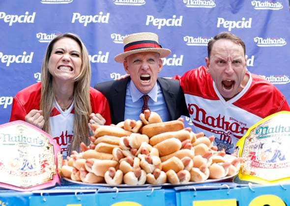Bilder des Jahres 2023, News 07 Juli News Themen der Woche KW27 News Bilder des Tages Event host George Shea stands with 2022 champion s Joey Chestnut and Miki Sudo at the 107th Nathan s Famous Fourth of July International Hot Dog Eating Contest weigh-in ceremony on Monday, July 3, 2023 in New York City.  NYP20230703101 JOHNxANGELILLO