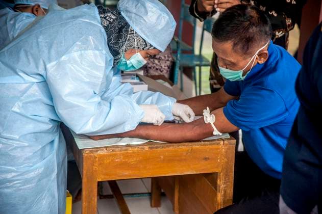 (230707) -- YOGYAKARTA, July 7, 2023 -- A health worker takes blood sample from a man for testing at Candirejo village in Gunung Kidul district, Yogyakarta, Indonesia, on July 7, 2023. One person has been confirmed dead from anthrax and 85 others have found to be infected after all of them consumed infected meat in Indonesia s Yogyakarta province, said local authorities on Tuesday. (Photo by Xinhua) INDONESIA-YOGYAKARTA-ANTHRAX AgungxSupriyanto 