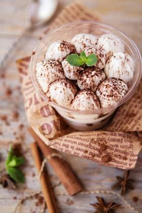 tiramisu in a glass cup decorated with cocoa powder and mint leaves Classic tiramisu in a glass cup decorated with cocoa powder and mint leaves Copyright: xZoonar.com NATALIIAxZHEKOVAx 16061730