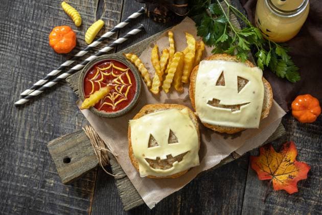 Halloween party food. Halloween party fun ghost burger, ketup sauce and potatoes frie on a wooden table. Top view flat lay background. Halloween party food. Halloween party fun ghost burger, ketup sauce and potatoes frie on a wooden table. Top view flat lay background. Copyright: xZoonar.com ELENAxHRAMOVAx 20360222