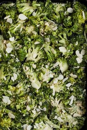 From above green broccoli stems with cheese and pepper placed on wooden background preparing to cook TwoInspirations_ID15005_458351_004 Copyright: xTwoxInspirationsx RECORD DATE NOT STATED Model Released