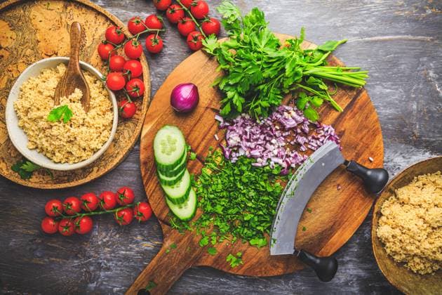 Preparing traditional oriental salad Tabouleh with couscous or bulgur Preparing traditional oriental salad Tabouleh with couscous or bulgur, ingredients on cutting board Copyright: xZoonar.com IngridxBalabanovax 20448955