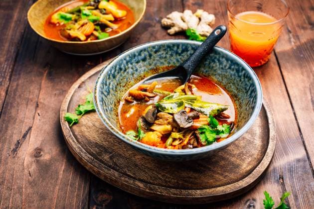 Thai red vegetarian curry with mushrooms and vegetables on wooden table Thai red vegetarian curry with mushrooms and vegetables on wooden table Copyright: xZoonar.com IngridxBalabanovax 20484383