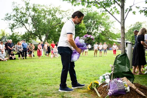 July 22, 2023, Toronto, ON, Canada: Friends and family members of Julianna Kozis and Reese Fallon, place flowers near trees planted in their honour, during a gathering to mark five years since the attack on the city s Danforth Avenue, at Withrow Park in Toronto, Saturday July 22, 2023. Toronto Canada  - ZUMAc35_ 20230722_zaf_c35_084 Copyright: xChristopherxKatsarovx