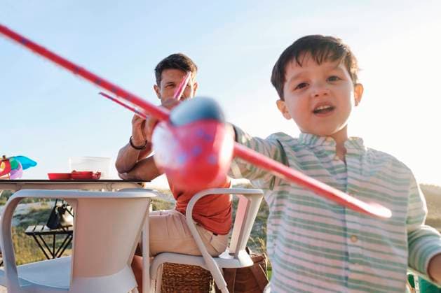 Creative Highlights Symbolbilder Boy playing with toy airplane on sunny day model released, Symbolfoto property released, ASGF03832