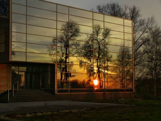 Creative Highlights World Mirroring the sunset and trees in the windows of the building. Moravany, South Moravian Region, Czechia R_WEWE230720-1219015-01
