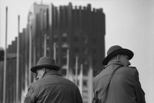Moscow, Russia. Civilians stand near the House of Soviets of the Russian Federation, damaged when tanks of the Taman Division shelled the building on October 4, 1993 during the storming of the building by supporters of the Russian president within a standoff between the Supreme Soviet of the Russian Federation and Russian President Boris Yeltsin. Valery Khristoforov TASS  19305500