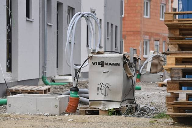 Themenfoto Waermepumpe. Noch verpackte Waermepumpe der Marke Viessmann steht vor einem Neubau,Reihenhaus in Bayern. *** Theme photo Waermepumpe Still packed heat pump of the brand Viessmann stands in front of a new building,terraced house in Bavaria