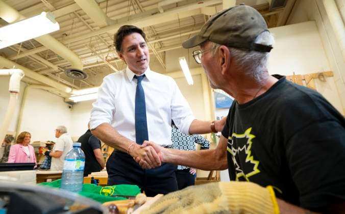 July 31, 2023, Hamilton, Ont, CAN: Prime Minister Justin Trudeau chats with Bob McLaughlin, 72, about his wood working project during a visit to Sackville Hill Senior Recreation Centre in Hamilton, Ont., Monday, July 31, 2023. Hamilton CAN  - ZUMAc35_ 20230731_zaf_c35_072 Copyright: xPeterxPowerx
