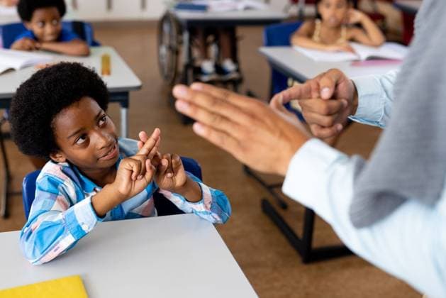 Diverse male teacher teaching school boy using sign language in class at elementary school Diverse male teacher teaching school boy using sign language in class at elementary school. School, disability and education, unaltered., model released, , property released, Cape Town, South Africa, 01.04.2023, 4070166.jpg, people,diverse,male,teacher teaching,school,boy,using,sign language,class,elementary school,disability,education,unaltered,student,study,learning,classroom,college,university,knowledge,learn,lesson,studying,disabled,teacher,book,handicap,handicapped,elementary,wheelchair,kid,childhood,notebook,teaching,sign,language Child,Boy,Male,Multiracial,Black,Girl,Female,Mid Adult,Man