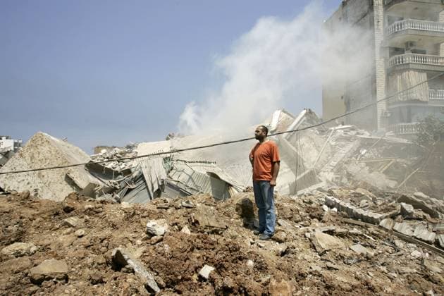 Europeans are evacuated from Beirut while israeli airstrikes carry on A man walks through the fuming remains of a building in the Shiite neighborhood of Choueifat in the southern edge of Beirut after an Israeli bomb flattened the building early in the morning on July 18, 2006. Israel also struck a Lebanese army base outside Beirut and flattened a house near the border, killing at least 31 people in a new wave of bombings, while Hezbollah fired rockets at northern Israel. The international community stepped up diplomatic efforts to end the conflict, which has sent foreigners fleeing by land, sea and air. Photo by Michael Dorhn ABACAPRESS.COM Beirut Lebanon  Copyright: xDohrnxMichael ABACAx 102036_07 DohrnxMichael ABACAx 102036_07
