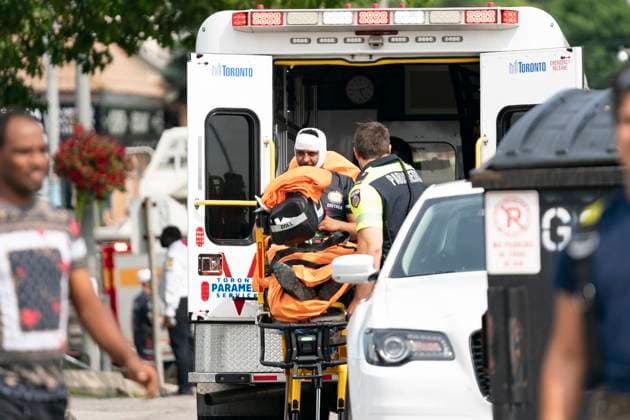 August 5, 2023, Toronto, Canada: Toronto Paramedics treat a patient at the scene of a protest that turned violent in Earlscourt Park in Toronto. Toronto police say one person was stabbed and eight others were injured during a protest in the city s west end. Toronto Canada  - ZUMAc35_ 20230805_zaf_c35_004 Copyright: xArlynxMcadoreyx